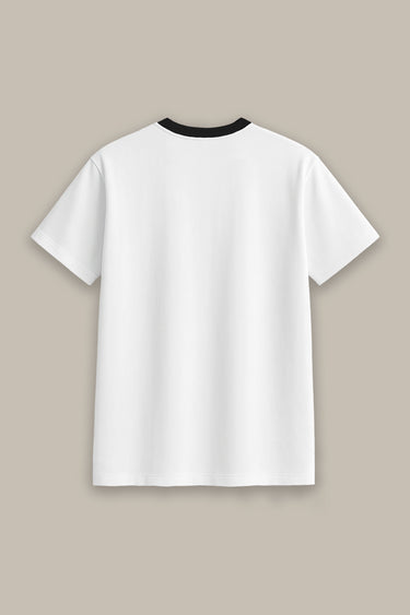 White t-shirt with black trim on a beige background